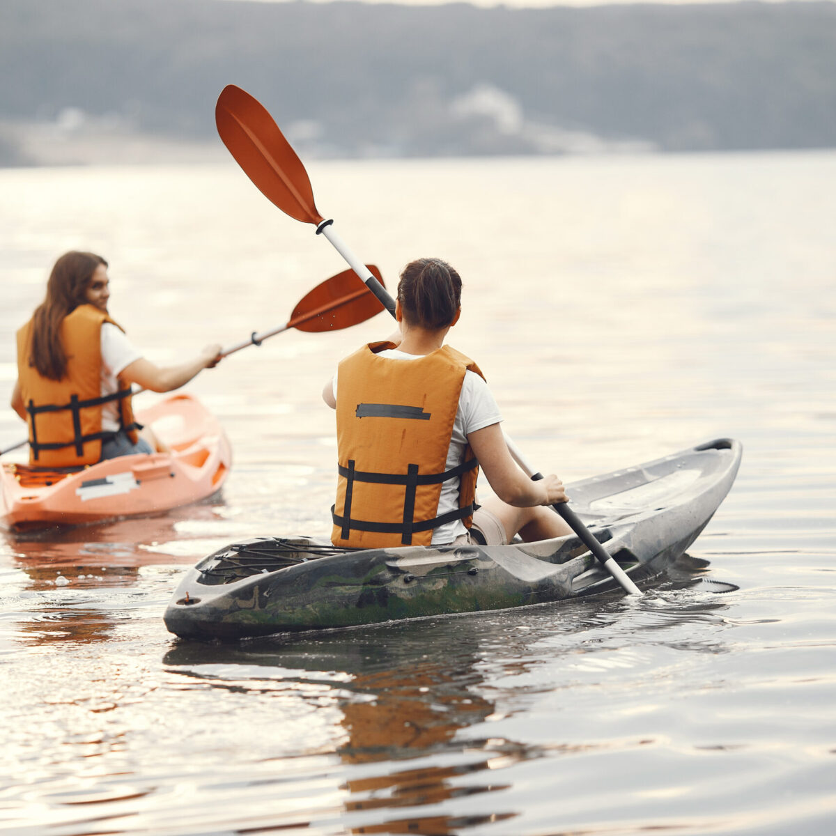 Women paddling on a lake in a kayak "АРГОН-385" - надувной двухместный пак-каяк из ПВХ для экспедиций